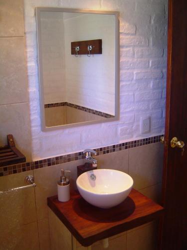 a bathroom with a white sink and a mirror at Aloha Village in La Pedrera