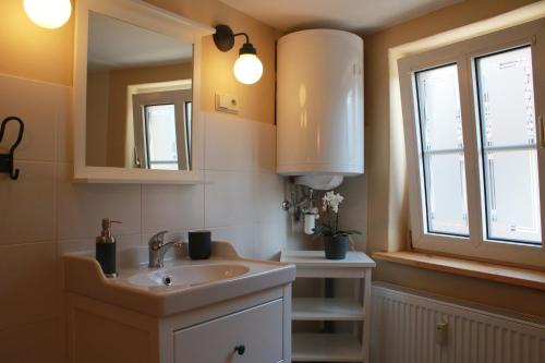 a bathroom with a sink and a window at Klopstock´s Herberge in Quedlinburg