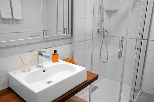 a white bathroom with a sink and a shower at TUI MAGIC LIFE Calabria - All Inclusive in Pizzo