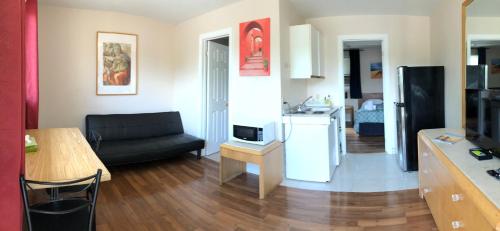 a living room with a couch and a kitchen at Wasaga Motel Inn in Wasaga Beach