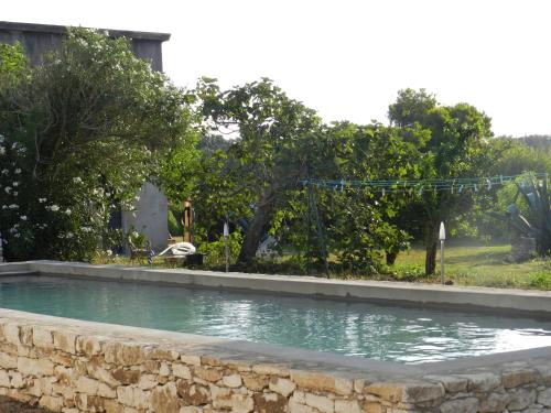 a swimming pool with a water slide in a yard at A Loghja Di Cavallo Morto in Bonifacio