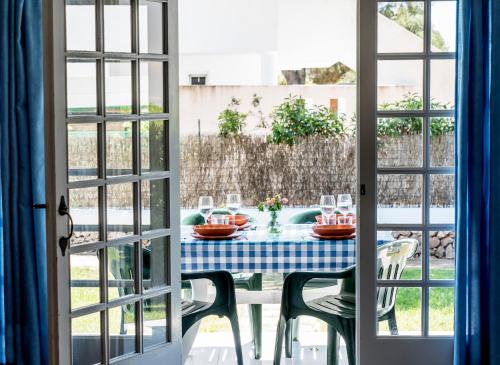 a table with a blue and white checkered table cloth at Apartamentos Las Brisas I & II in Cala'n Bosch