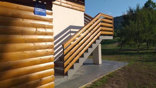 a wooden staircase on the side of a building at Studio Apartmani Patricia in Smoljanac