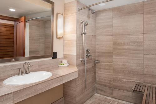 a bathroom with a sink and a shower at Humphreys Half Moon Inn in San Diego