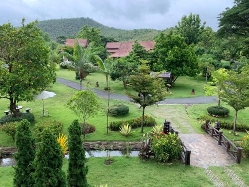 a view of a park with trees and a path at Papai Country Lodge SHA in Ban Mae Pong