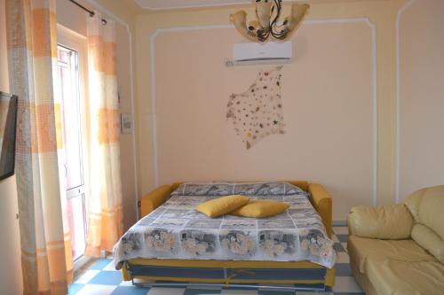 a bedroom with a bed with two pillows on it at casa vacanze dei navigatori on the sea in Pontecagnano