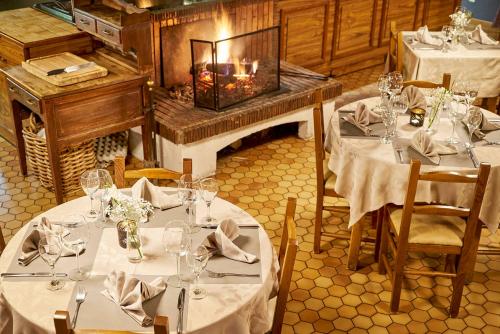 a dining room with two tables with white tableclothsurrencyangering at DC Hotel & Restaurant Brussels South in Brussels