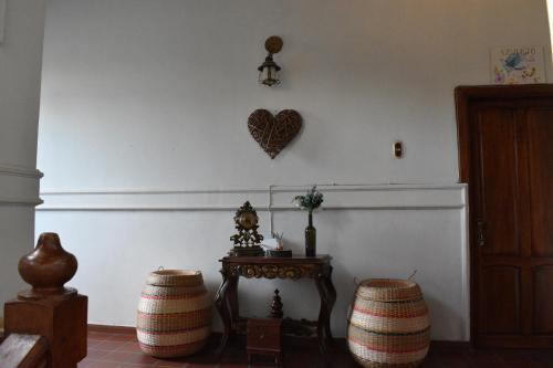 a room with two stools and a heart on the wall at Casa Isabelita in Mompos