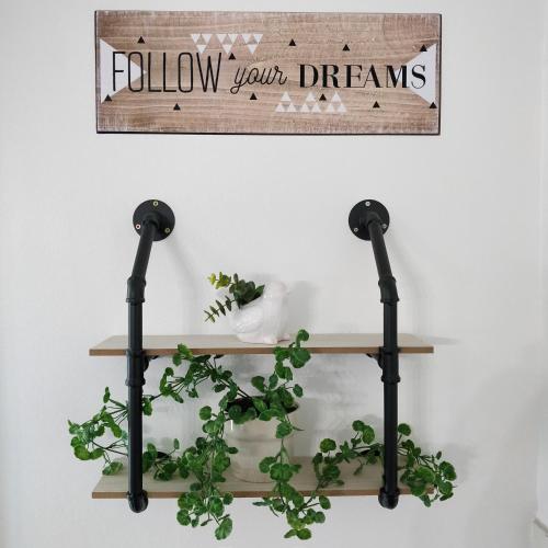 a shelf with some plants on a wall at Les Clés du Bonheur by Beds4Wanderlust, 47m2 avec Terrasse privative & Parking-RER B TGV 10min-Orly 20min in Massy