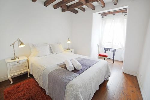 a bedroom with a bed and a dresser at Rossio Hostel in Lisbon
