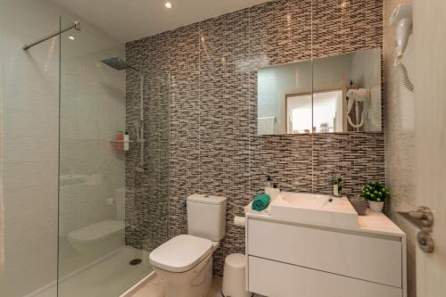 a bathroom with a toilet and a sink and a shower at Villa Blue Horizon in Playa Blanca