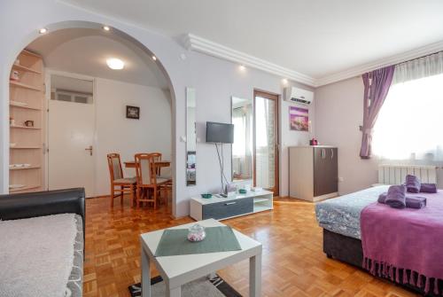 - un salon avec un lit et une table dans l'établissement Apartment Gloria, à Belgrade