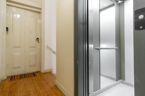 an empty hallway with a door and a wooden floor at LV Premier Apartments Baixa- CR in Lisbon