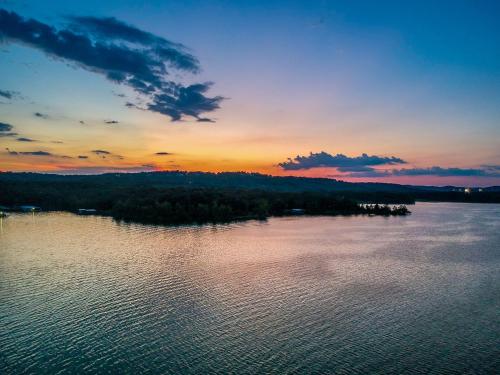a large body of water with a sunset in the background at Table Rock Resorts at Indian Point in Branson