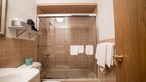 a bathroom with a shower with a toilet and a sink at Holland Hotel Free Parking Jersey City in Jersey City