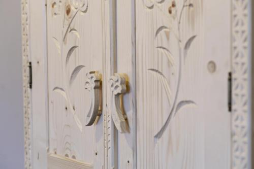 a pair of wooden doors with gold handles at Willa Siumno in Białka Tatrzanska