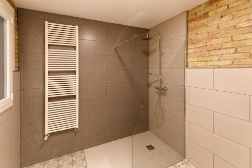 a bathroom with a shower with a glass door at Lo passeig in Tremp