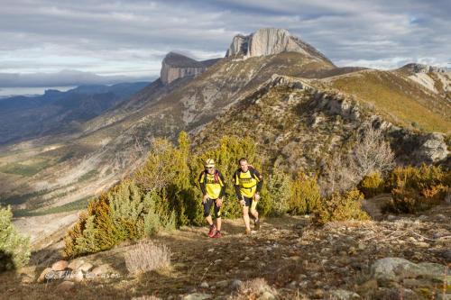 two people walking on a mountain trail at Lo passeig in Tremp