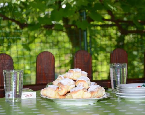 a plate of donuts sitting on a table at Guesthouse Vila Natalija in Gornja Trepča