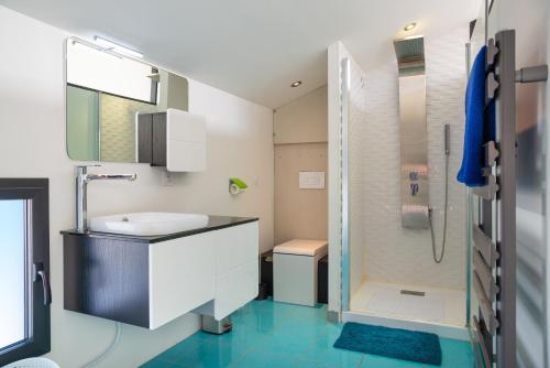 a bathroom with a sink and a shower at Maison piscine centre ville La Tranche-sur-Mer in La Tranche-sur-Mer