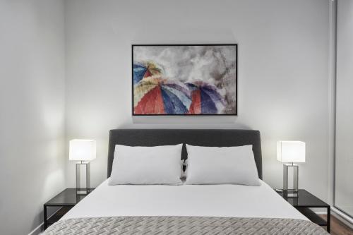 a bedroom with a white bed and two lamps at Valaoritou Boutique Apartment,Kolonaki in Athens