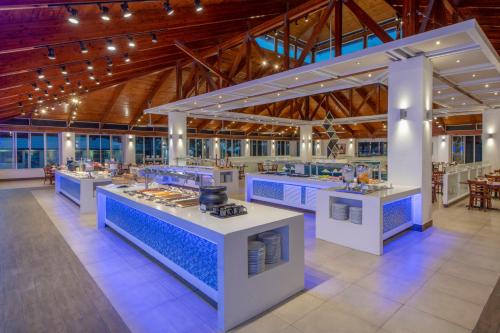 a large kitchen with blue counter tops in a building at Viva Fortuna Beach by Wyndham, A Trademark All Inclusive in Freeport
