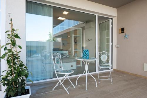 a pair of chairs and a table on a balcony at Candiano Palace in Portopalo