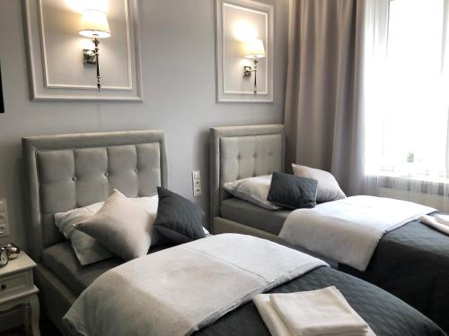 A bed or beds in a room at Family & Business Sauna Apartments Plac Wolności CENTRUM Downtow, UNIKAT - 5 Bedroom with Private Sauna, Bath with Hydromassage, Parking, Catering Options