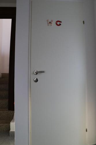 a white door with a sign on top of it at The Lakehouse Villa Neusiedl am See Wienerstraße 8 in Neusiedl am See