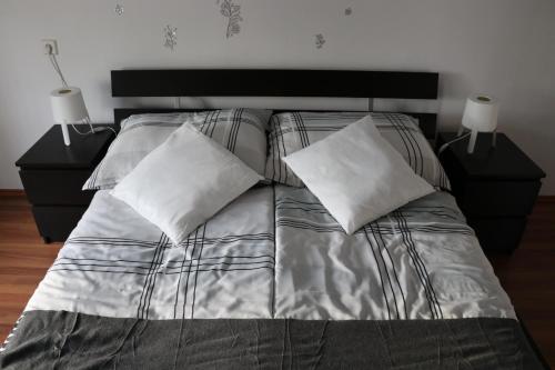 a bed with two pillows on it in a bedroom at The Lakehouse Villa Neusiedl am See Wienerstraße 8 in Neusiedl am See