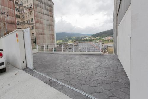 a balcony of a building with a view of a city at Noray Apartamentos Viveiro in Viveiro