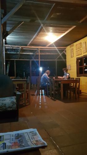 a man sitting at a table in a room at Nawal in Lanquín