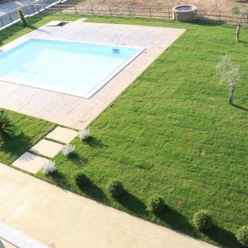an aerial view of a yard with a swimming pool at LE TORRI DEL CILENTO in Santa Maria di Castellabate