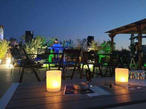a table with lights on top of a patio at Be My Guest Athens in Athens