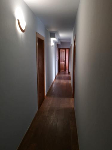 an empty hallway with a long floor and a light at Au Bord De L'eau in Durbuy