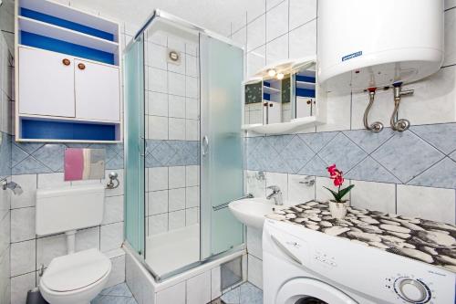 a small bathroom with a sink and a toilet at Apartments Mise in Makarska