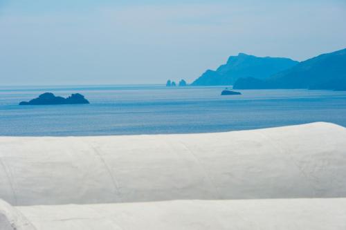 a view of the ocean with mountains in the background at Villa Il Frantoio and Lilmar in Praiano