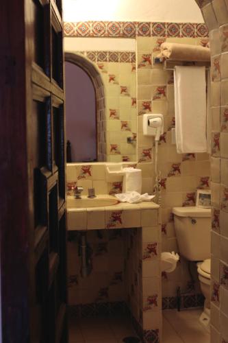 a bathroom with a sink and a toilet at Posada del Tepozteco - Hotel & Gallery in Tepoztlán