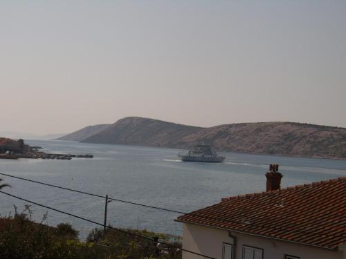 a boat in a large body of water at Apartments Stengl in Rab