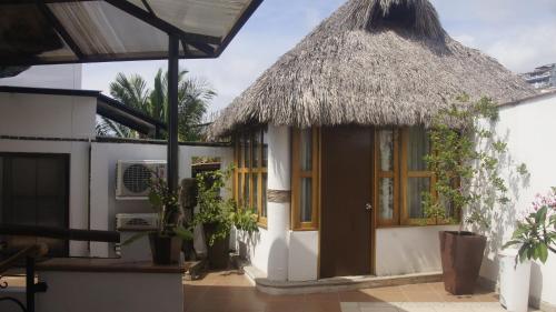 a small house with a thatch roof at Casa del Parque Vallarta in Puerto Vallarta