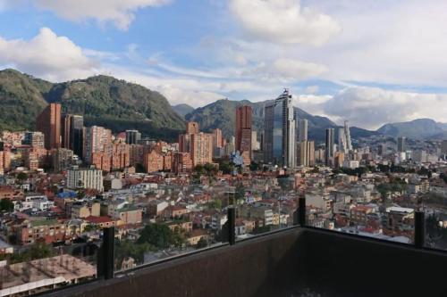 a view of a city with buildings and mountains at Apartamento Park Way Bogotá in Bogotá