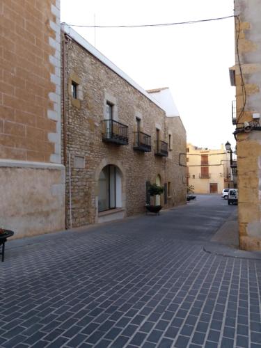 a brick building with a cobblestone street at EL LLIMONER in Sant Jordi