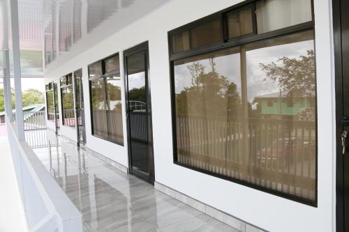 a row of windows in a white building at Hostel Cattleya - Monteverde, Costa Rica in Monteverde Costa Rica
