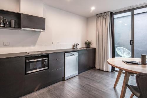 a kitchen with a table and a dining room at Change Overnight in Launceston