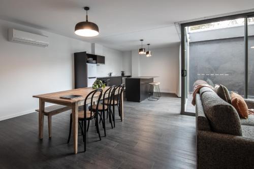 a dining room and kitchen with a table and chairs at Change Overnight in Launceston