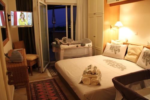 a bedroom with a bed with a baby carriage on it at Luxurious Apartment With Sea & Mountain View in Litochoro
