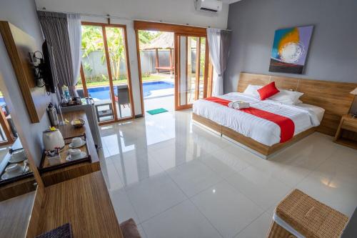 a bedroom with a bed and a pool at Bali Dive Resort and Spa in Tulamben