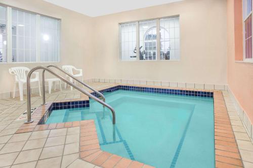 a swimming pool with a slide in a building at Microtel Inn and Suites by Wyndham Appleton in Appleton
