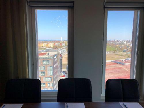 two large windows in a room with a table and chairs at Best Western Malmo Arena Hotel in Malmö