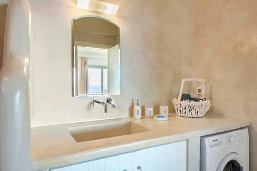 a bathroom with a sink and a washing machine at Aelion Villa in Vari